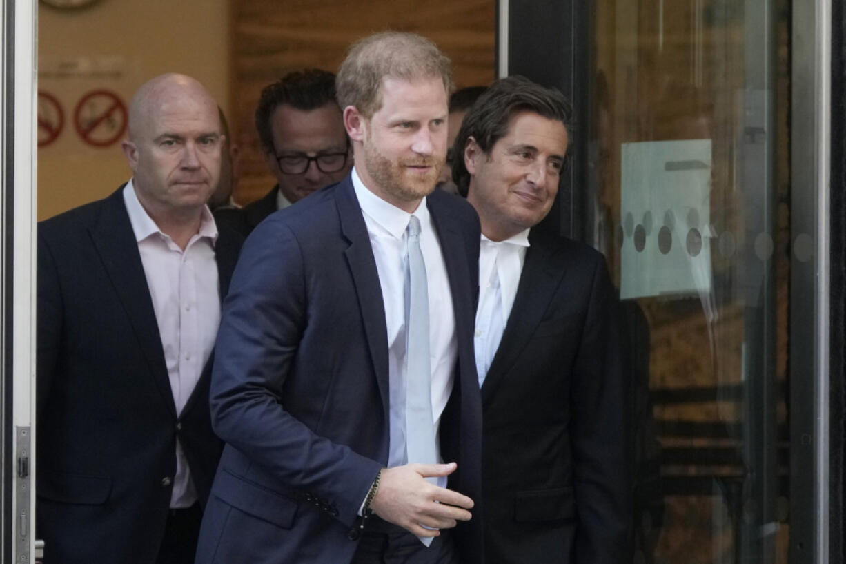 FILE- Prince Harry, centre, and David Sherborne, Prince Harry's lead lawyer, right, leave the High Court after giving evidence in London, Wednesday, June 7, 2023. A London judge has allowed Prince Harry's lawsuit against the publisher of The Sun tabloid to go to trial on claims the newspaper used unlawful methods to gather information about him.