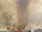 In this photo provided by the National Park Service, smoke rises from the York Fire in the Mojave National Preserve, Calif., Sunday, July 30, 2023. A massive wildfire burning out of control in California's Mojave National Preserve was spreading rapidly amid erratic winds, while firefighters reported progress against another major blaze to the southwest that prompted evacuations.