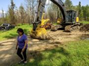 Carrol Johnston, who lost her home in a May wildfire, walks through her property in the East Prairie Metis Settlement, Alberta, on Wednesday, July 4, 2023. Johnston, who has been living in a nearby town, is awaiting a modular home so she can return to the land.