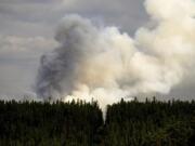 Smoke billows from the Donnie Creek wildfire burning north of Fort St. John, British Columbia, on Sunday, July 2, 2023.