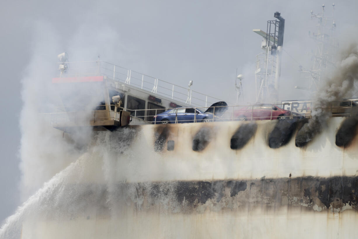 Emergency personnel battle against a fire aboard the Italian-flagged Grande Costa d'Avorio cargo ship at the Port of Newark, Friday, July 7, 2023, in Newark, N.J.  The cargo ship burned for a third day Friday at the port after a fire that claimed the lives of two Newark firefighters Augusto "Augie" Acabou and Wayne "Bear" Brooks Jr. , and exposed gaps in the ability of fire crews to respond to emergencies on hulking container ships.