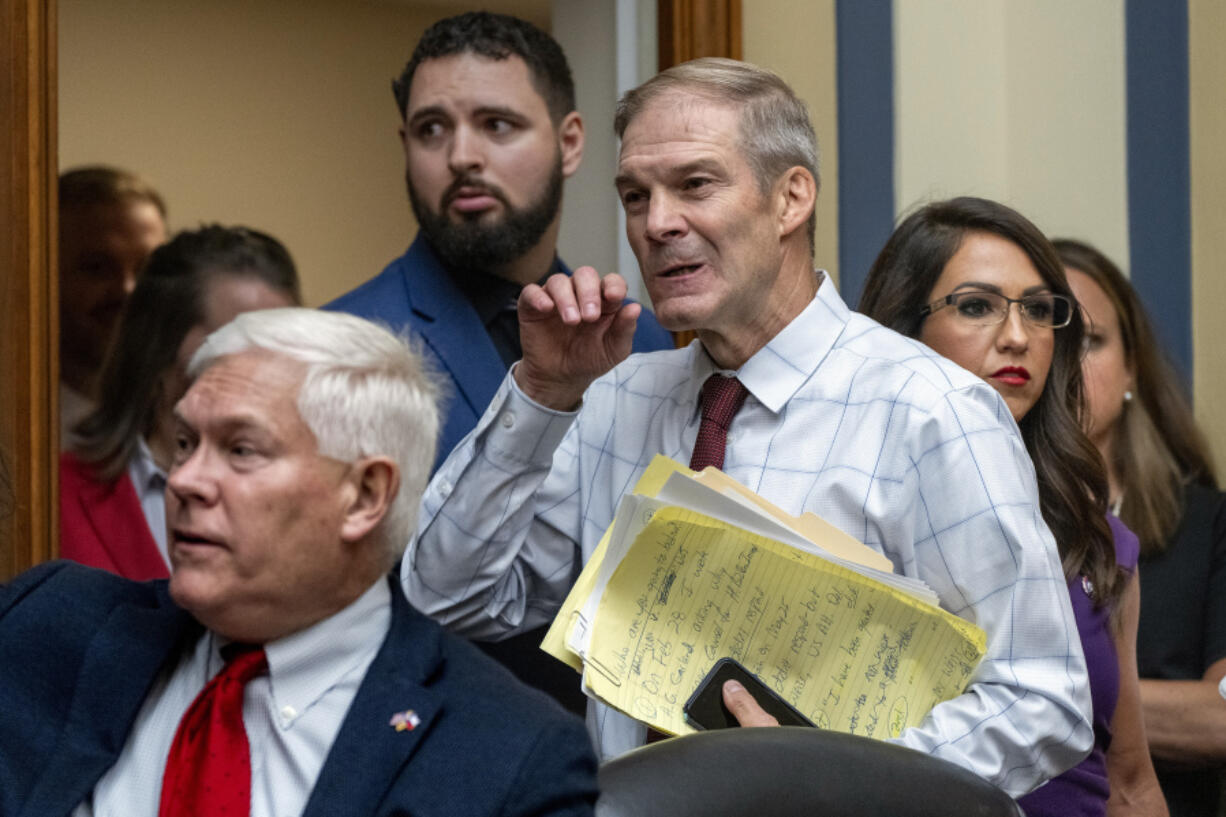 House Judiciary Committee Chair Jim Jordan, R-Ohio, center, flanked by Rep. Pete Sessions, R-Texas, left, and Rep. Lauren Boebert, R-Colo., arrives as the House Oversight and Accountability Committee holds a hearing to charge that the Justice Department interfered with a yearslong investigation into Hunter Biden, at the Capitol in Washington, Wednesday, July 19, 2023. (AP Photo/J.