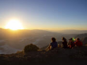 Park visitors watch the sunset on Tuesday, July 11, 2023, in Death Valley National Park, Calif. July is the hottest month at the park with an average high of 116 degrees (46.5 Celsius).