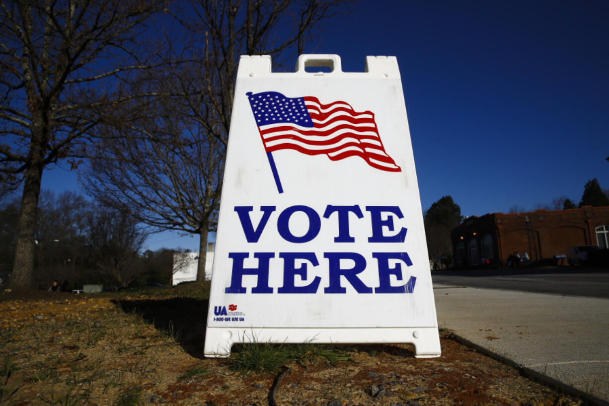 FILE - A vote here sign is seen outside a polling place during the South Carolina primary, Saturday, Feb. 29, 2020, in Columbia, S.C. Months after the Democratic Party approved President Joe Biden's plan to overhaul its primary order to better reflect a deeply diverse voter base, implementing the revamped order has proven anything but simple. Party officials now expect the process to continue through the end of the year -- even as the 2024 presidential race heats up all around it.