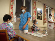 FILE - A health worker refreshes a resident of a retirement home in Isturitz, southwestern France, June 15, 2022. Crushing temperatures that blanketed Europe during the summer of 2022 may have led to more than 61,000 heat-related deaths, according to a study published Monday, July 10, 2023.