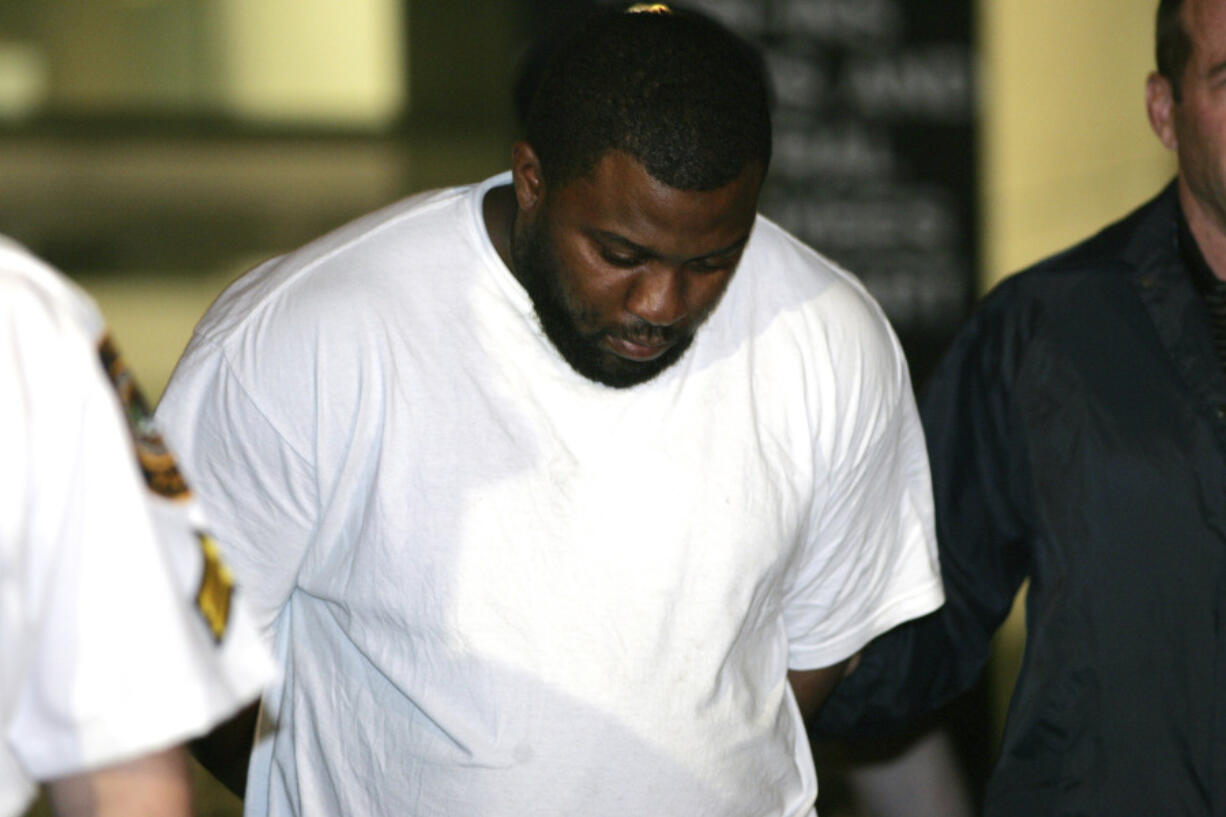 FILE - Onta Williams is led by police officers from a federal building in New York, Thursday, May 21, 2009, after being arrested by the FBI on charges related to a plot to bomb targets in The Bronx section of New York. Four men snared in an infamous post-9/11 terrorism sting were ordered freed from prison Thursday, July 27, 2023, with a judge finding that they had been "hapless, easily manipulated and penurious petty criminals" caught up in a plot driven by an overzealous FBI and a dodgy informant.