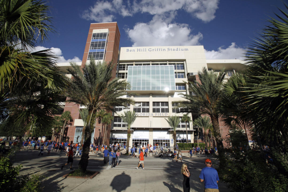 FILE - Fans arrive for an NCAA college football game against UAB at Ben Hill Griffin Stadium at the University of Florida in Gainesville, Fla., Sept. 10, 2011.