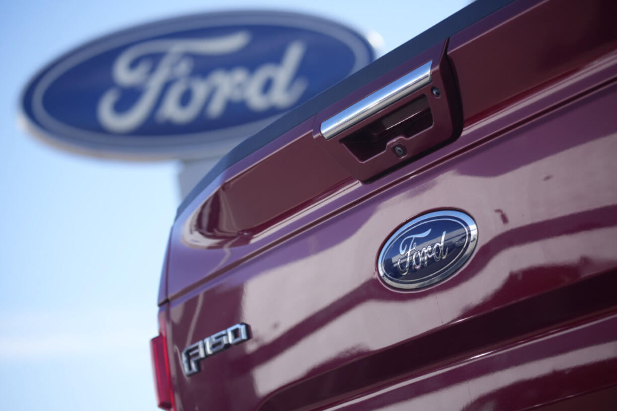 FILE - A 2021 F-150 pickup truck at a Ford dealer in southeast Denver, Oct. 24, 2021. Ford is recalling more than 870,000 newer F-150 pickup trucks in the U.S. because the electric parking brakes can turn on unexpectedly. The recall covers certain pickups from the 2021 through 2023 model years with single exhaust systems. Ford's F-Series pickups are the top-selling vehicles in the U.S.