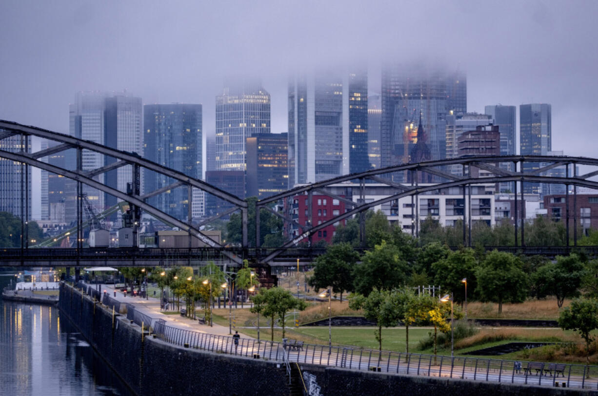 Clouds hang over the buildings of the banking district in Frankfurt, Germany, Friday, July 28, 2023. The German economy is still failing to grow, figures showed Friday, as the country that should be the industrial powerhouse for all of Europe struggles with high energy prices, rising borrowing costs and a lagging rebound from key trading partner China.