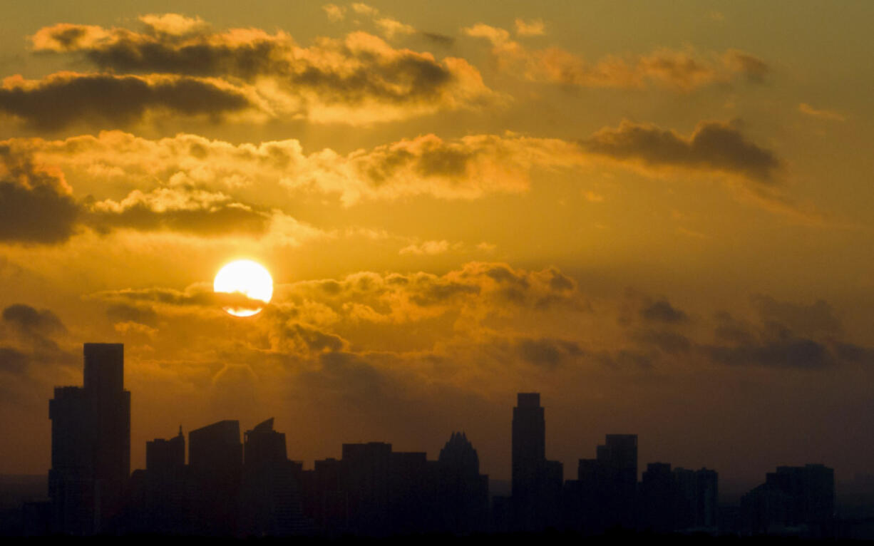 The sun rises over downtown Austin, Texas, on Friday, June 30, 2023.