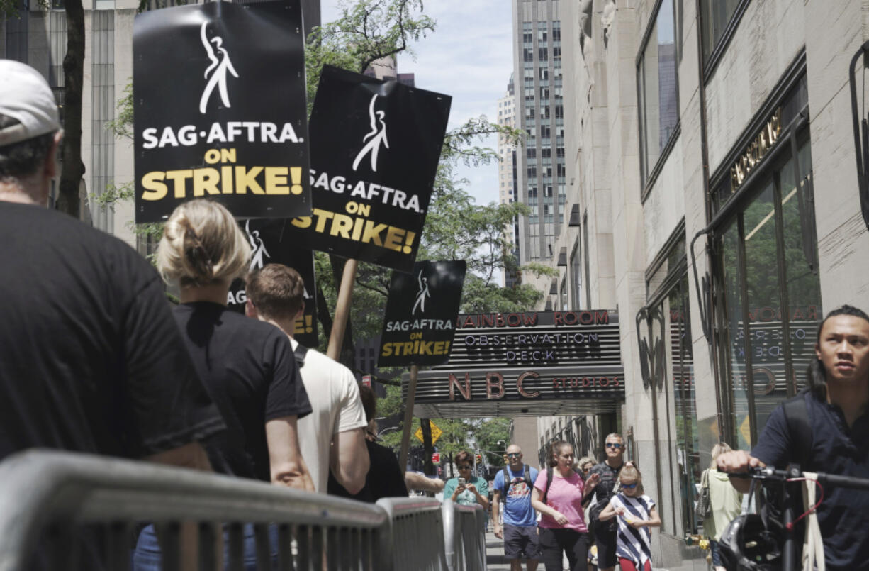 Writers and actors join forces as they walk the picket line during a strike, Friday, July 14, 2003, at NBC Universal Studios in New York.