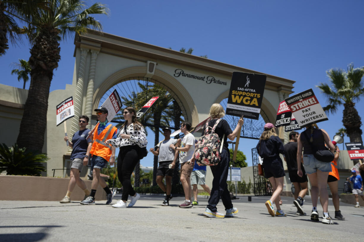 Picketers gather outside Paramount Pictures during a Writers Guild rally on Thursday, July 13, 2023, in Los Angeles. The rally follows a press conference announcing a strike by The Screen Actors Guild-American Federation of Television and Radio Artists. This marks the first time since 1960 that actors and writers will picket film and television productions at the same time. (AP Photo/Mark J.