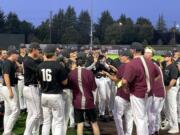 Ridgefield Raptors players and coaches cheer during their post-game meeting after clinching a West Coast League playoff berth with a win over the Portland Pickles on Wednesday, July 5, 2023, at Ridgefield Outdoor Recreation Complex.