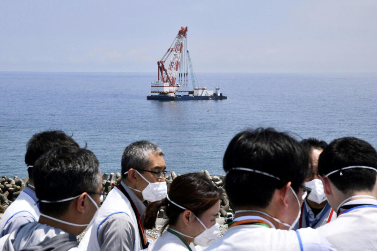 A work ship is seen off shore where Tokyo Electric Power Company Holdings said it installed the last piece of an undersea tunnel dug to be used to release the water offshore, during a media tour to the Fukushima Daiichi nuclear power plant in Fukushima, northern Japan Monday, June 26, 2023. All equipment needed for the release into the sea of treated radioactive wastewater from the wrecked Fukushima nuclear plant has been completed and will be ready for a safety inspection by Japanese regulators this week, the plant operator said Monday, as opposition to the plan continues in and outside Japan over safety concerns.