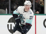 FILE - Seattle Kraken defenseman Vince Dunn controls the puck during Game 2 of an NHL hockey Stanley Cup second-round playoff series against the Dallas Stars, May 4, 2023, in Dallas. The Kraken have re-signed top defenseman Dunn to a four-year, $29.4 million contract, locking up one of their core pieces coming off the best season of his career.