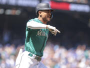 Seattle Mariners' Julio Rodriguez celebrates after hitting a solo home run during the third inning of a baseball game against the Toronto Blue Jays, Saturday, July 22, 2023, in Seattle.