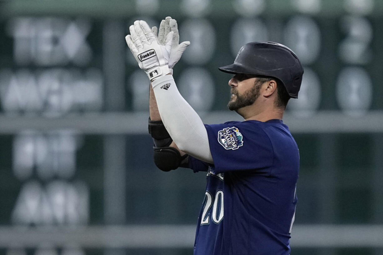 Seattle Mariners designated hitter Mike Ford celebrates after hitting a three-run double during the fourth inning of a baseball game against the Houston Astros, Friday, July 7, 2023, in Houston. (AP Photo/Kevin M.