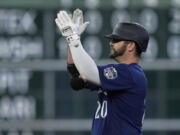 Seattle Mariners designated hitter Mike Ford celebrates after hitting a three-run double during the fourth inning of a baseball game against the Houston Astros, Friday, July 7, 2023, in Houston. (AP Photo/Kevin M.