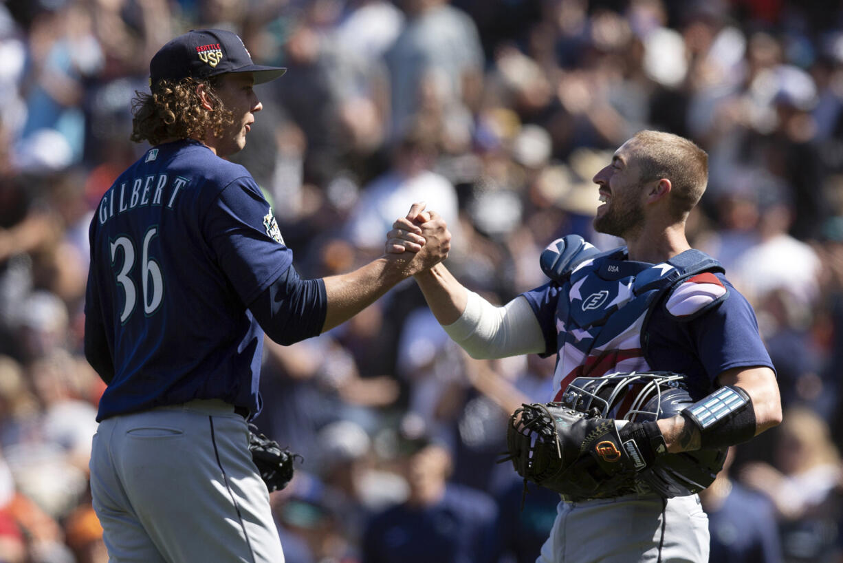 Seattle Mariners starting pitcher Logan Gilbert (36) and catcher Tom Murphy celebrate Gilbert's five-hitter against the San Francisco Giants in a baseball game, Tuesday, July 4, 2023, in San Francisco. The Mariners won 6-0. (AP Photo/D.