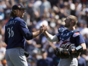 Seattle Mariners starting pitcher Logan Gilbert (36) and catcher Tom Murphy celebrate Gilbert's five-hitter against the San Francisco Giants in a baseball game, Tuesday, July 4, 2023, in San Francisco. The Mariners won 6-0. (AP Photo/D.