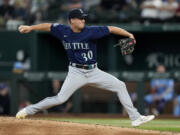 Seattle Mariners relief pitcher Trevor Gott winds up to throw to the Texas Rangers in the sixth inning of a baseball game, Sunday, June 4, 2023, in Arlington, Texas.