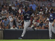 Seattle Mariners' Julio Rodriguez (44) advances toward home base in celebration after hitting a home run during the eighth inning of a baseball game against the Minnesota Twins, Tuesday, July 25, 2023, in Minneapolis.(AP Photo/Stacy Bengs)