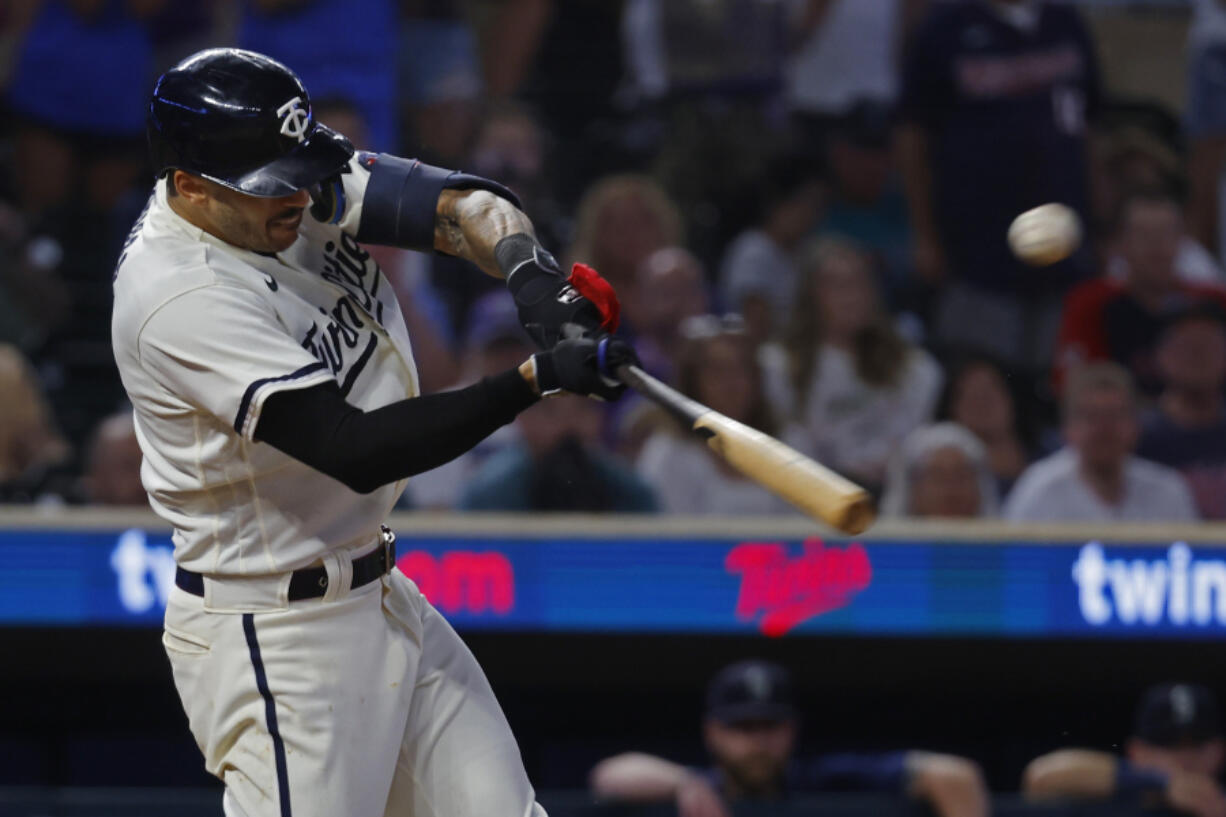 Minnesota Twins' Carlos Correa hits an RBI single to defeat the Seattle Mariners in the 10th inning of a baseball game Monday, July 24, 2023, in Minneapolis.