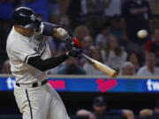 Minnesota Twins' Carlos Correa hits an RBI single to defeat the Seattle Mariners in the 10th inning of a baseball game Monday, July 24, 2023, in Minneapolis.