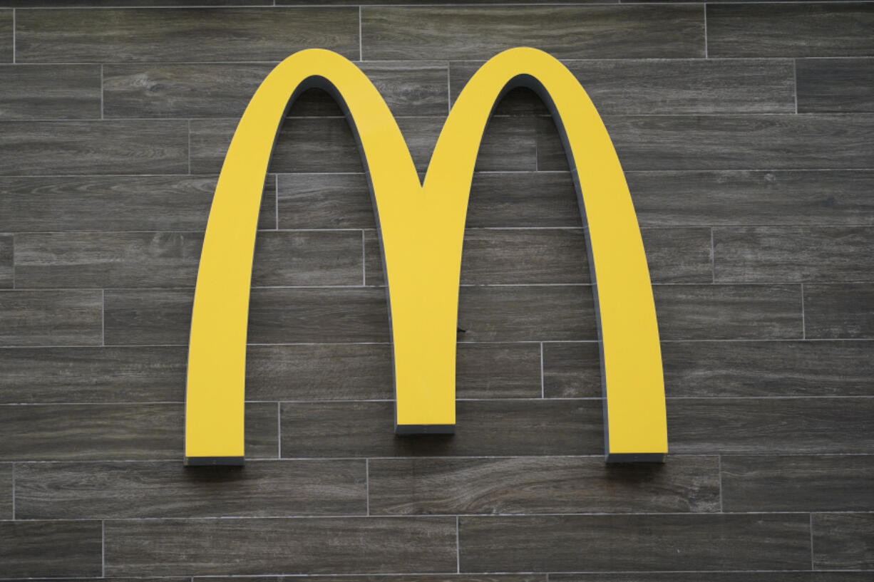 FILE - A McDonald's logo hangs outside of a location in Havertown, Pa., on April 26, 2022. A McDonald's franchise that controls 12 restaurants in metro New Orleans violated child labor laws affecting more than 70 minors, the U.S. Department of Labor said Tuesday, July 25, 2023. The division also found similar violations at four McDonald's locations operated in Texas.