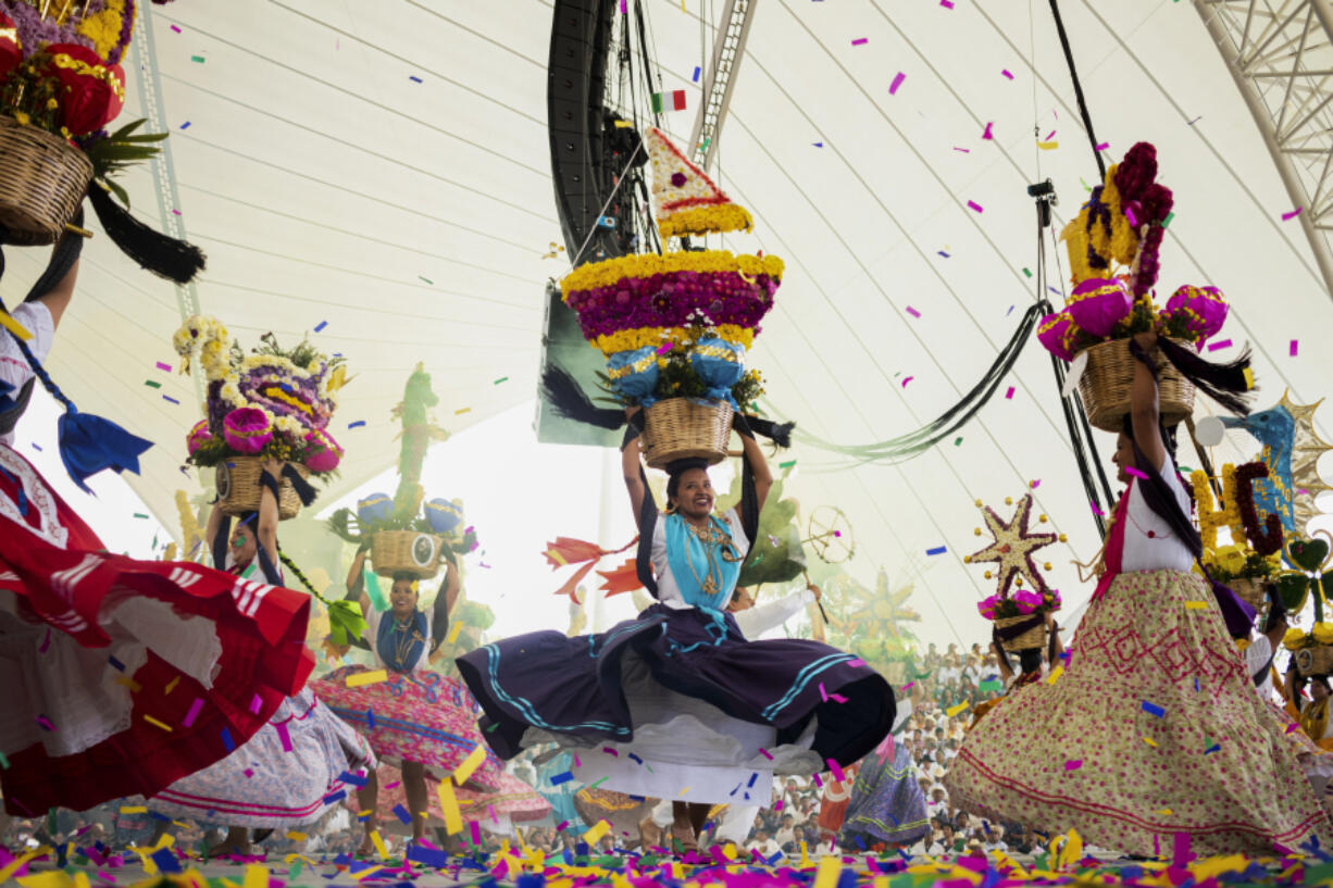 Dancers perform July 17 on the first day of the Guelaguetza in Oaxaca, Mexico. During the government-sponsored event, 16 Indigenous ethnic groups and the Afro-Mexican community promote their traditions through dances, parades and craft sales.