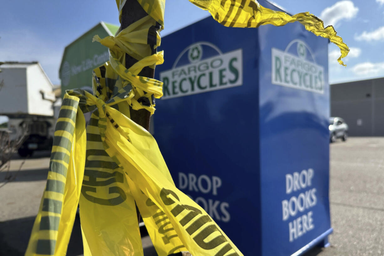 Police crime tape remained Saturday, July 15, 2023, in Fargo, N.D., near the intersection where one police officer was fatally shot and two others were critically wounded on Friday, July 14. Authorities have said the suspect was also killed in the shooting, and a civilian was injured.