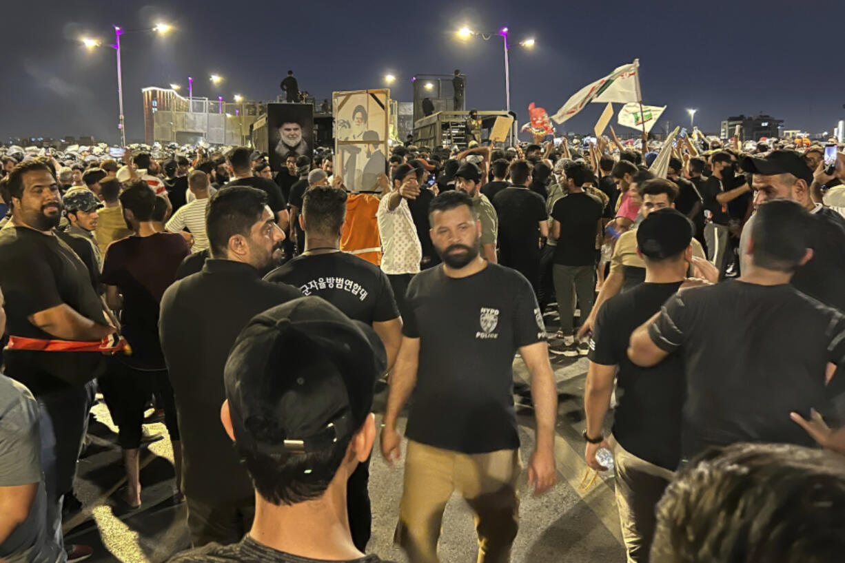 Protesters gather in Baghdad's Tahrir Square, carrying Iraqi flags and images of influential Iraqi Shiite cleric and political leader Muqtada al-Sadr, Saturday, July 22, 2023, following reports of the burning of a Quran carried out by a ultranationalist group in front of the Iraqi Embassy in Copenhagen. Protesters attempted to cross the Jumhuriya bridge leading to the Green Zone, where the Danish embassy is, but were pushed back by security forces.