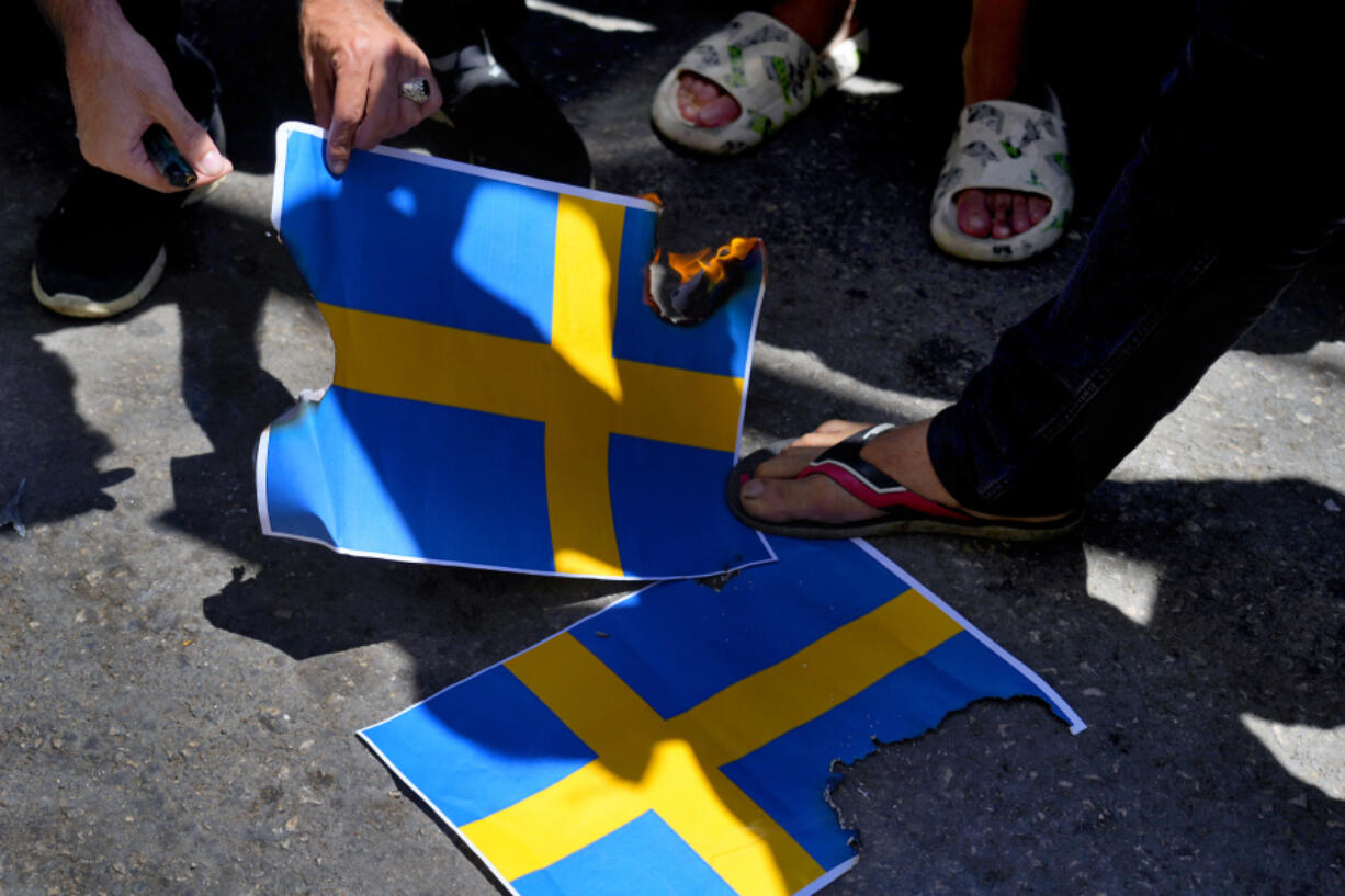 Hezbollah supporters trample representations of the Swedish flags during a rally denouncing the desecration of the Quran after Friday prayers in the southern Beirut suburb of Dahiyeh, Lebanon, Friday, July 21, 2023. Muslim-majority nations expressed outrage Friday at the desecration of the Islamic holy book in Sweden. Following midday prayers, thousands took to the streets to show their anger, in some cases answering the call of religious and political leaders.