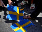 Hezbollah supporters trample representations of the Swedish flags during a rally denouncing the desecration of the Quran after Friday prayers in the southern Beirut suburb of Dahiyeh, Lebanon, Friday, July 21, 2023. Muslim-majority nations expressed outrage Friday at the desecration of the Islamic holy book in Sweden. Following midday prayers, thousands took to the streets to show their anger, in some cases answering the call of religious and political leaders.