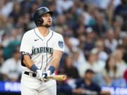 Seattle Mariners' Cal Raleigh watches his solo home run, his second of the night, against the Boston Red Sox go over the fence during the seventh inning of a baseball game, Monday, July 31, 2023, in Seattle.