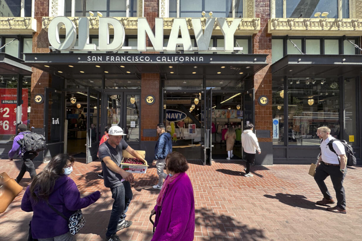 People make their way past the entrance to the flagship Old Navy store which is closing later this year in San Francisco, on June 21, 2023. San Francisco's downtown has seen an exodus of retailers and now a shopping mall owner is turning the complex over to its lender in the face of declining foot traffic and empty office space. While San Francisco faces some of its own unique issues, such as a heavy reliance on tech workers, most of them working largely remotely, the problems serve as warning signs for other downtowns across the country, which are also feeling some pain.