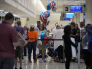 People wait for arriving passengers at Midway International Airport in Chicago Wednesday, July 12, 2023. A tornado touched down Wednesday evening near Chicago's O'Hare International Airport, prompting passengers to take shelter and disrupting hundreds of flights. (AP Photo/Nam Y.