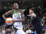 Seattle Storm's Ezi Magbegor drives to the basket as Chicago Sky's Elizabeth Williams defends during the first half of a WNBA basketball game Friday, July 28, 2023, in Chicago.