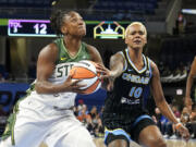 Seattle Storm's Jewell Loyd (24) drives to the basket as Chicago Sky's Courtney Williams defends during the first half of a WNBA basketball game Friday, July 28, 2023, in Chicago.