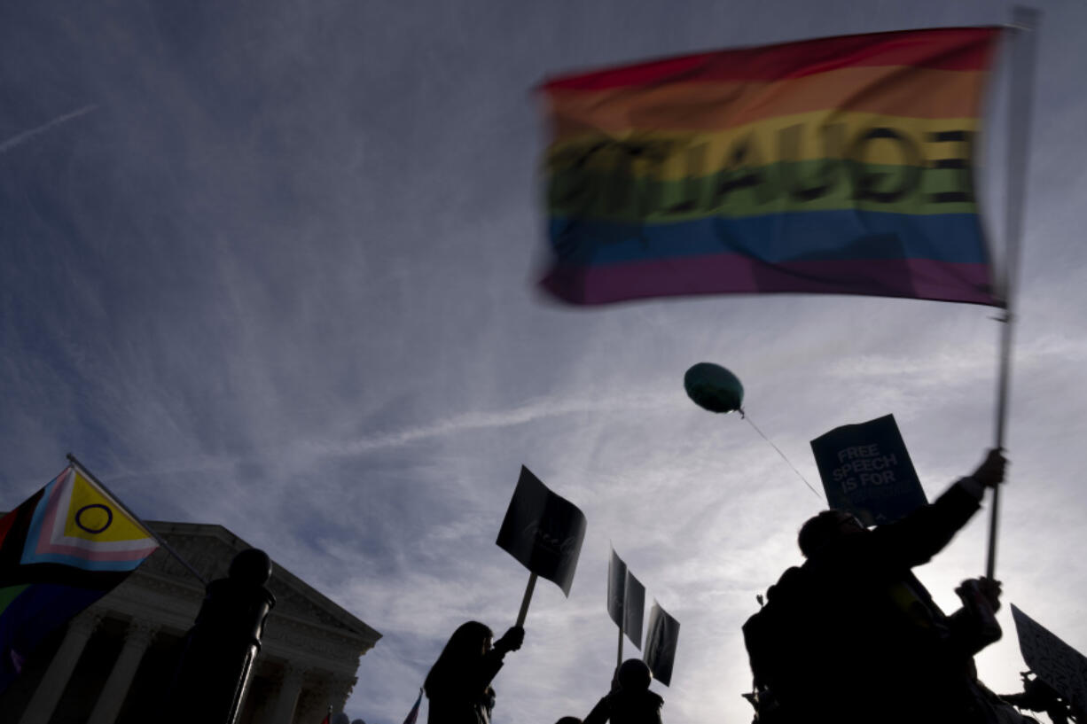 FILE - People on both sides of the debate rally outside the Supreme Court in Washington, Monday, Dec. 5, 2022. In a defeat for gay rights, the Supreme Court's conservative majority ruled Friday, June 30, 2023, Lorie Smith, a Christian graphic artist and website designer in Colorado, who wants to design wedding websites can refuse to work with same-sex couples.