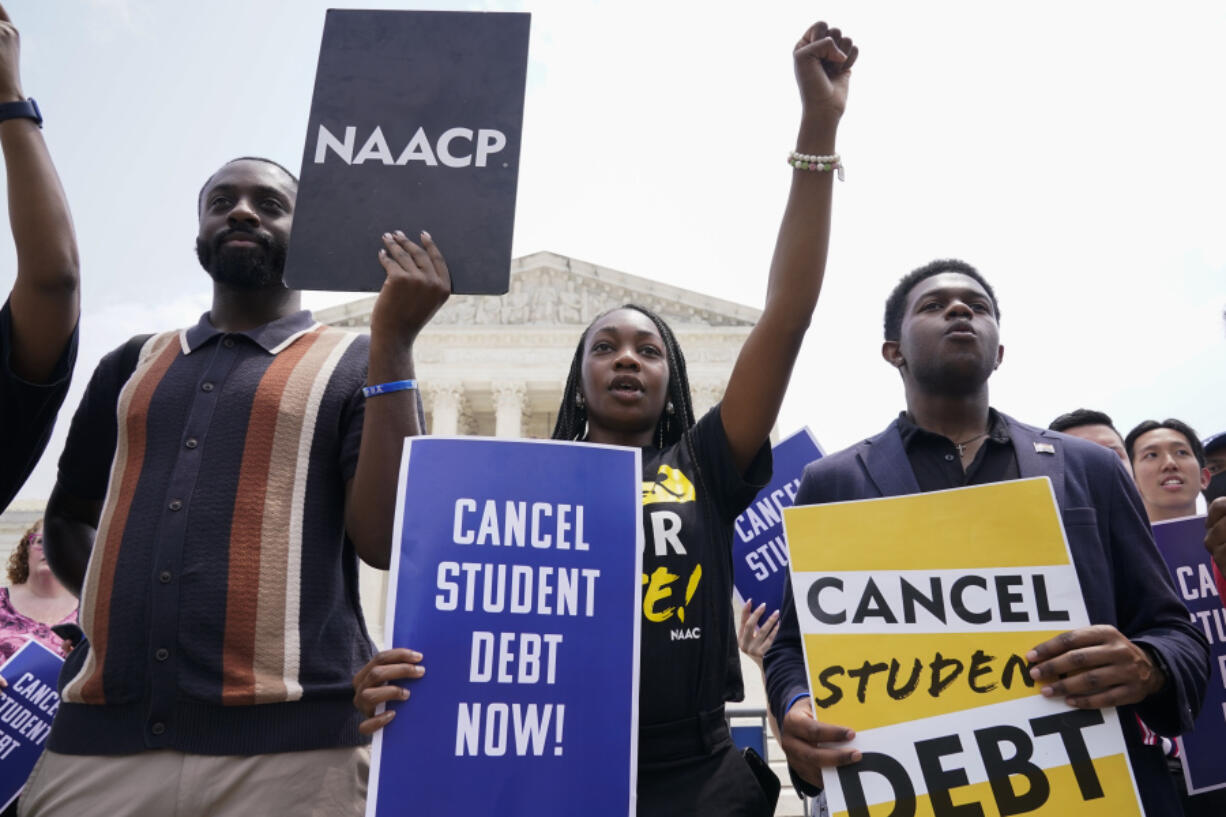 FILE - Jordan Braithwaite, 21, center, an undergrad at Grambling State University facing over $10,000 in student loans, demonstrates outside the Supreme Court, Friday, June 30, 2023, in Washington. A sharply divided Supreme Court has ruled that the Biden administration overstepped its authority in trying to cancel or reduce student loan debts for millions of Americans. Conservative justices were in the majority in Friday's 6-3 decision that effectively killed the $400 billion plan that President Joe Biden announced last year.