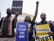 FILE - Jordan Braithwaite, 21, center, an undergrad at Grambling State University facing over $10,000 in student loans, demonstrates outside the Supreme Court, Friday, June 30, 2023, in Washington. A sharply divided Supreme Court has ruled that the Biden administration overstepped its authority in trying to cancel or reduce student loan debts for millions of Americans. Conservative justices were in the majority in Friday's 6-3 decision that effectively killed the $400 billion plan that President Joe Biden announced last year.