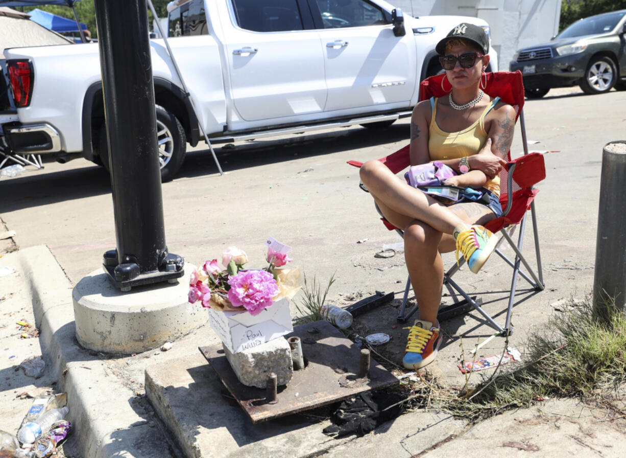 Ka'Desha Weatherly sits in the spot where her son, Paul Timothy Willis, 18, was killed in a shooting during a Fourth of July celebration the previous evening in Fort Worth, Texas, Tuesday, July 4, 2023. Authorities say several people were killed and others injured when shots were fired into a crowd of hundreds after a holiday festival in a Texas neighborhood. The shooting in the Fort Worth neighborhood of Como happened late Monday night, just hours after the annual ComoFest.