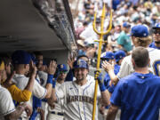 Seattle Mariners' Cal Raleigh celebrates in the dugout after hitting a solo home run off Detroit Tigers starting pitcher Reese Olson during the fourth inning of a baseball game, Sunday, July 16, 2023, in Seattle.