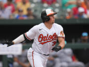 Baltimore Orioles' Adley Rutschman runs out of the box while hitting an infield single against the Minnesota Twins in the eighth inning of a baseball game, Sunday, July 2, 2023, in Baltimore. The Orioles won 2-1.