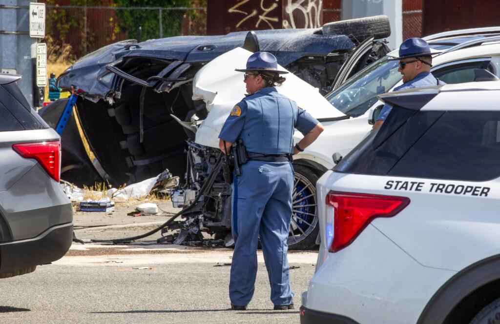 First responders investigate a crash that left six dead and three others injured on Sunday, July 16, 2023, in Tacoma.