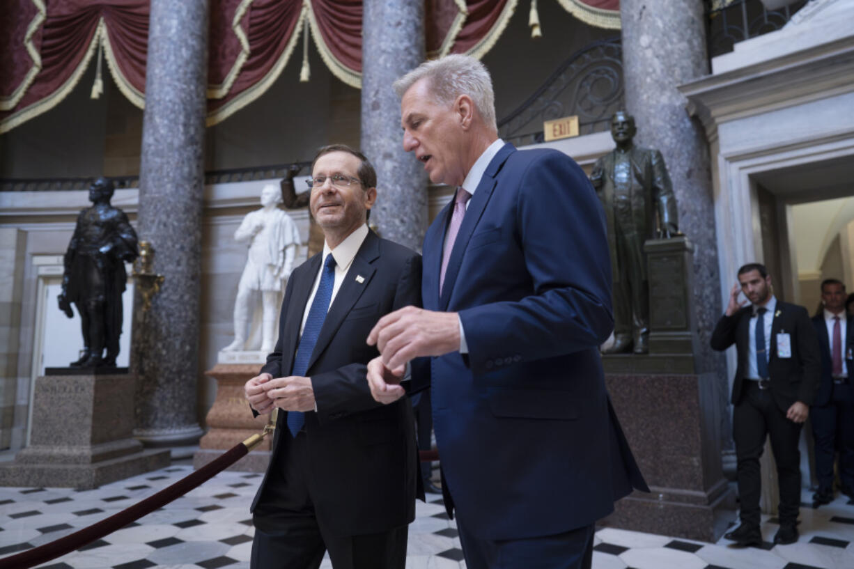 Israeli President Isaac Herzog, left, and Speaker of the House Kevin McCarthy, R-Calif., walk to a closed meeting before Herzog delivers an address to Congress in celebration of Israel's 75 years of independence, at the Capitol in Washington, Wednesday, July 19, 2023. (AP Photo/J.