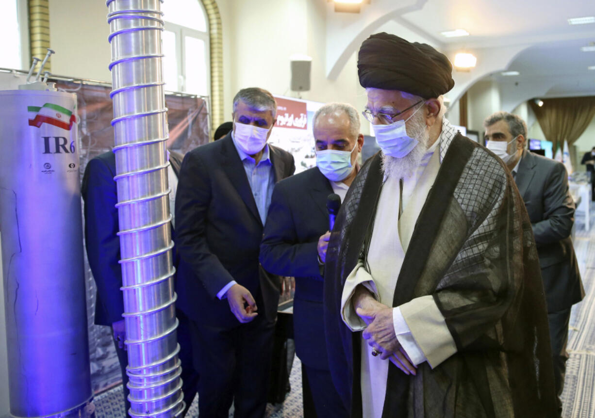 In this photo released by the office of the Iranian supreme leader, Supreme Leader Ayatollah Ali Khamenei, right, visits an exhibition of the country's nuclear achievements, at his office compound in Tehran, Iran, on June 11.