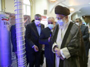 In this photo released by the office of the Iranian supreme leader, Supreme Leader Ayatollah Ali Khamenei, right, visits an exhibition of the country's nuclear achievements, at his office compound in Tehran, Iran, on June 11.