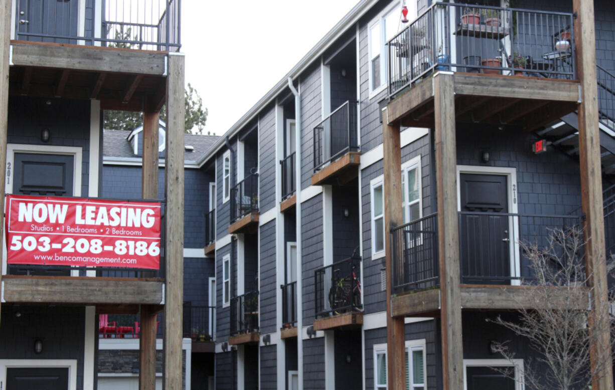 FILE - A 'Now Leasing' sign hangs off an apartment building staircase in southeast Portland, Ore., Dec. 9, 2021. The White House has announced a series of measures that it said would reduce the cost and increase the supply of housing while bolstering protection for renters. The measures announced Thursday, July 27, 2023, would provide communities with funding to reduce zoning barriers, expand financing for affordable and energy efficient housing as well as promoting the conversion of commercial buildings to residential housing.